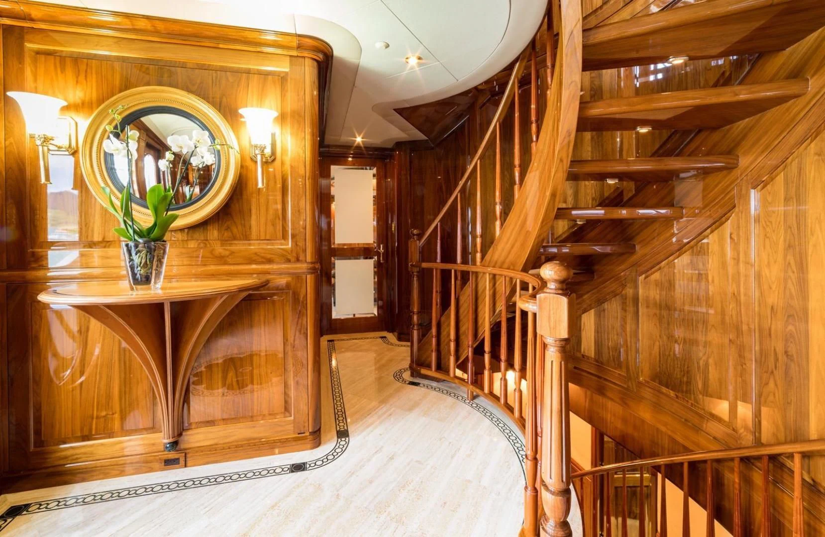 a wooden staircase with a clock aboard POPEYE Yacht for Sale