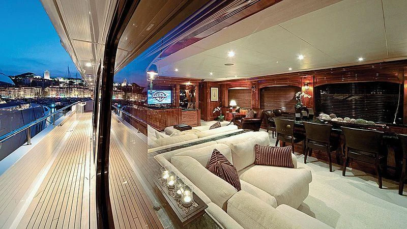 a large living room with a balcony aboard POPEYE Yacht for Sale