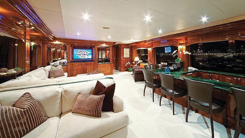 a large living room with a large kitchen and dining area aboard POPEYE Yacht for Sale