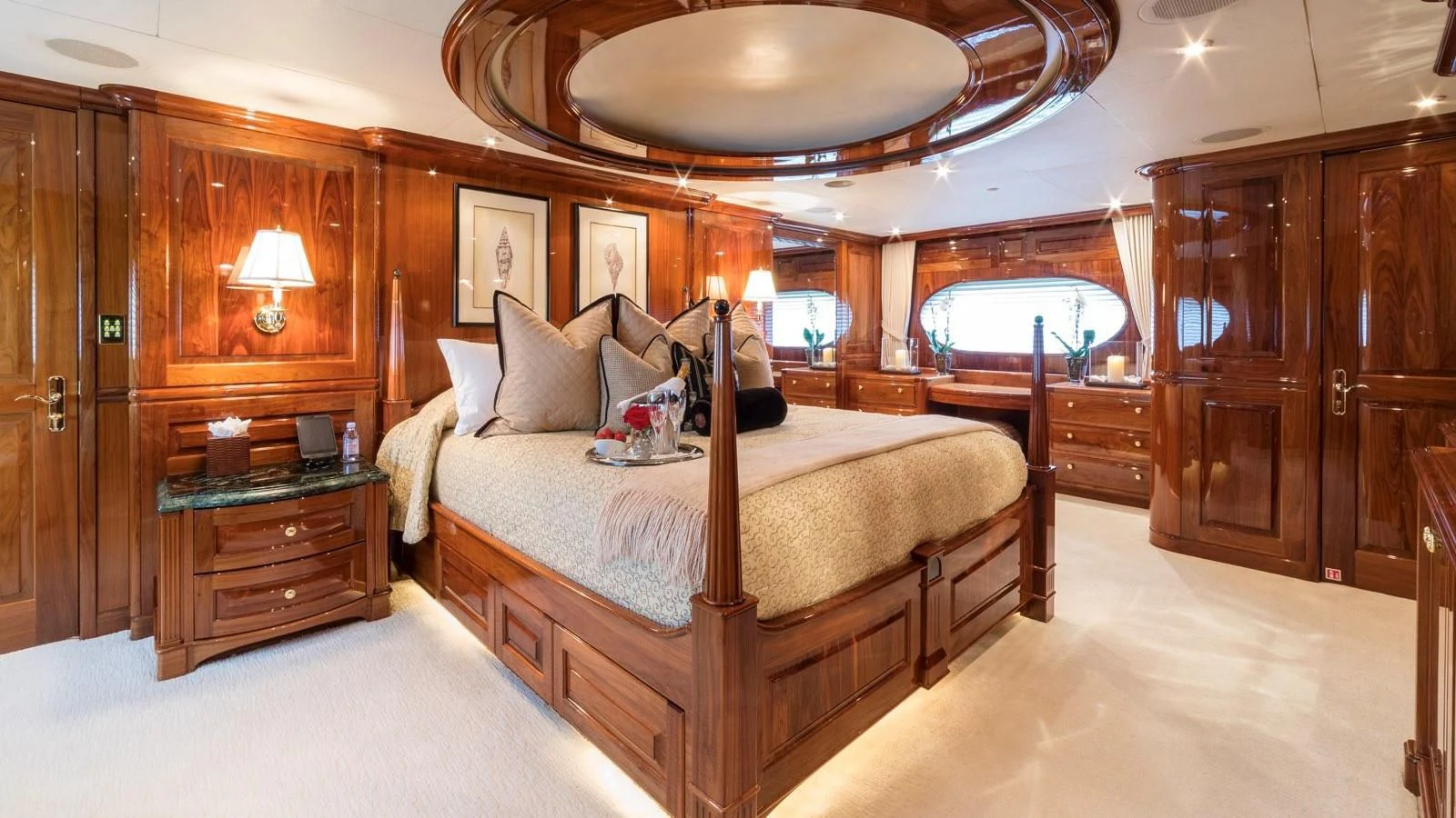 a bedroom with a bed and a dresser aboard POPEYE Yacht for Sale