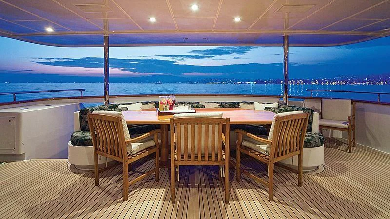 a table and chairs on a deck aboard POPEYE Yacht for Sale