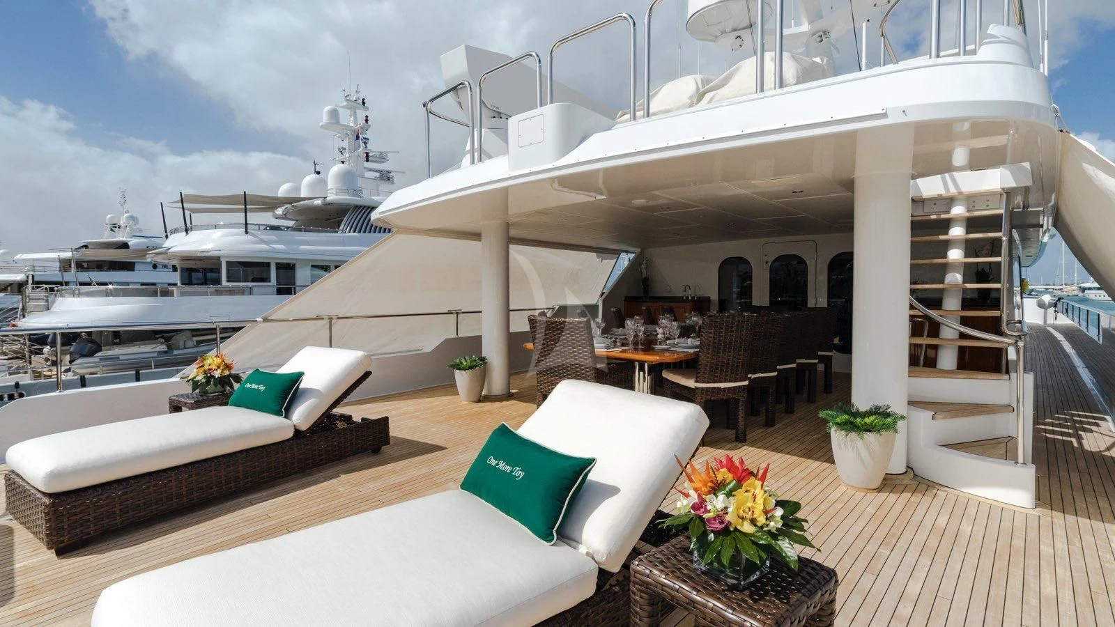 a room with a table chairs and a large ship in the background aboard POPEYE Yacht for Sale