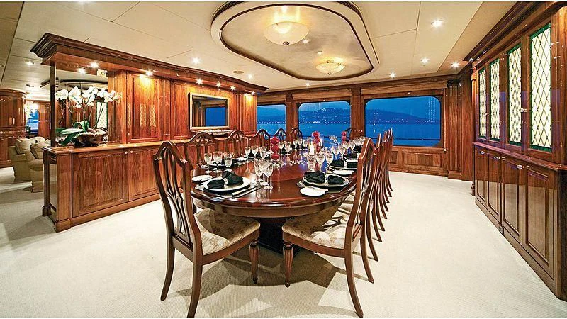 a dining room with a table and chairs aboard POPEYE Yacht for Sale