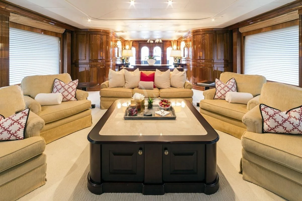 a living room with a table and couches aboard POPEYE Yacht for Sale