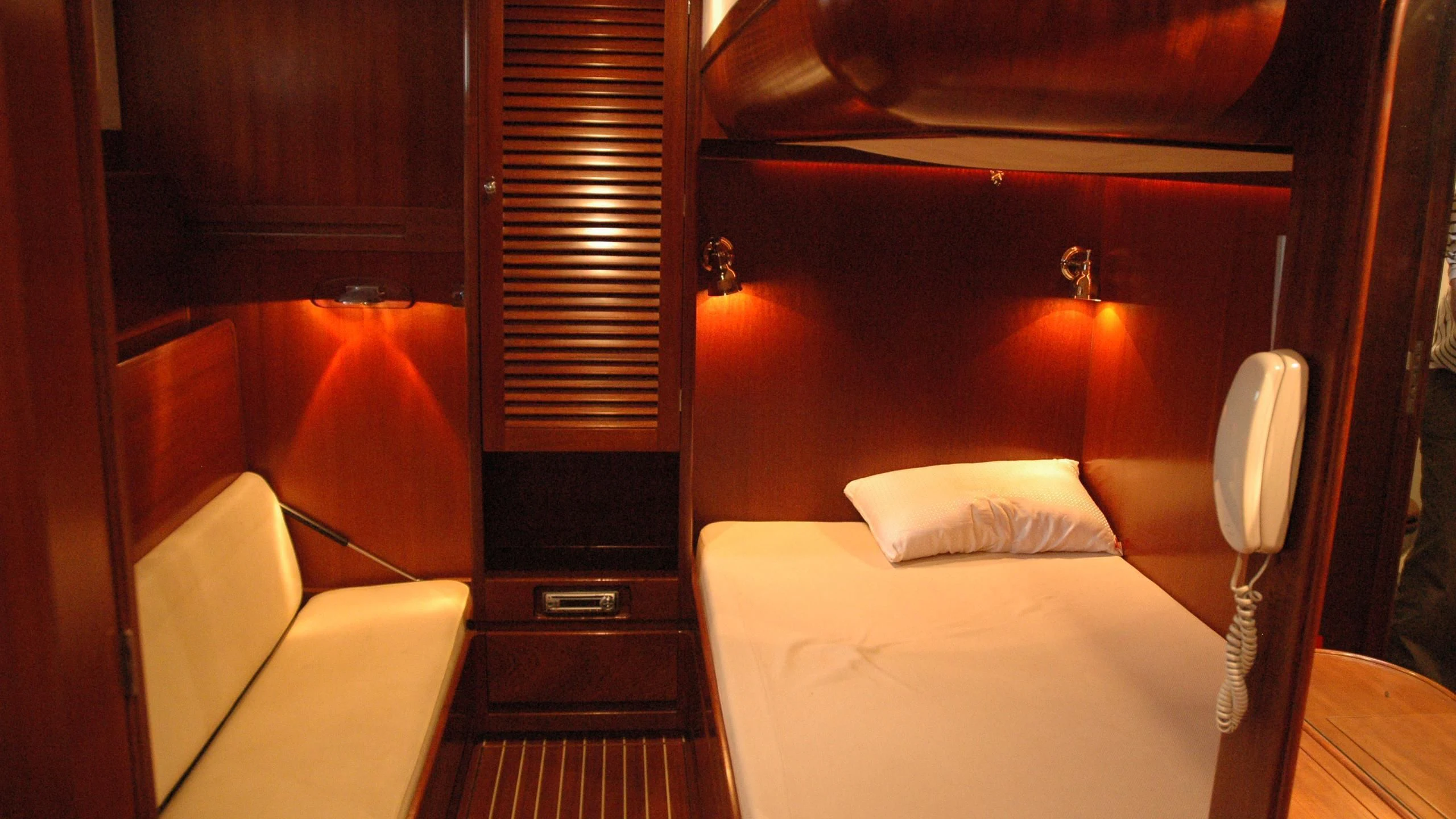 a room with a bed and a telephone aboard ISABEL Yacht for Sale