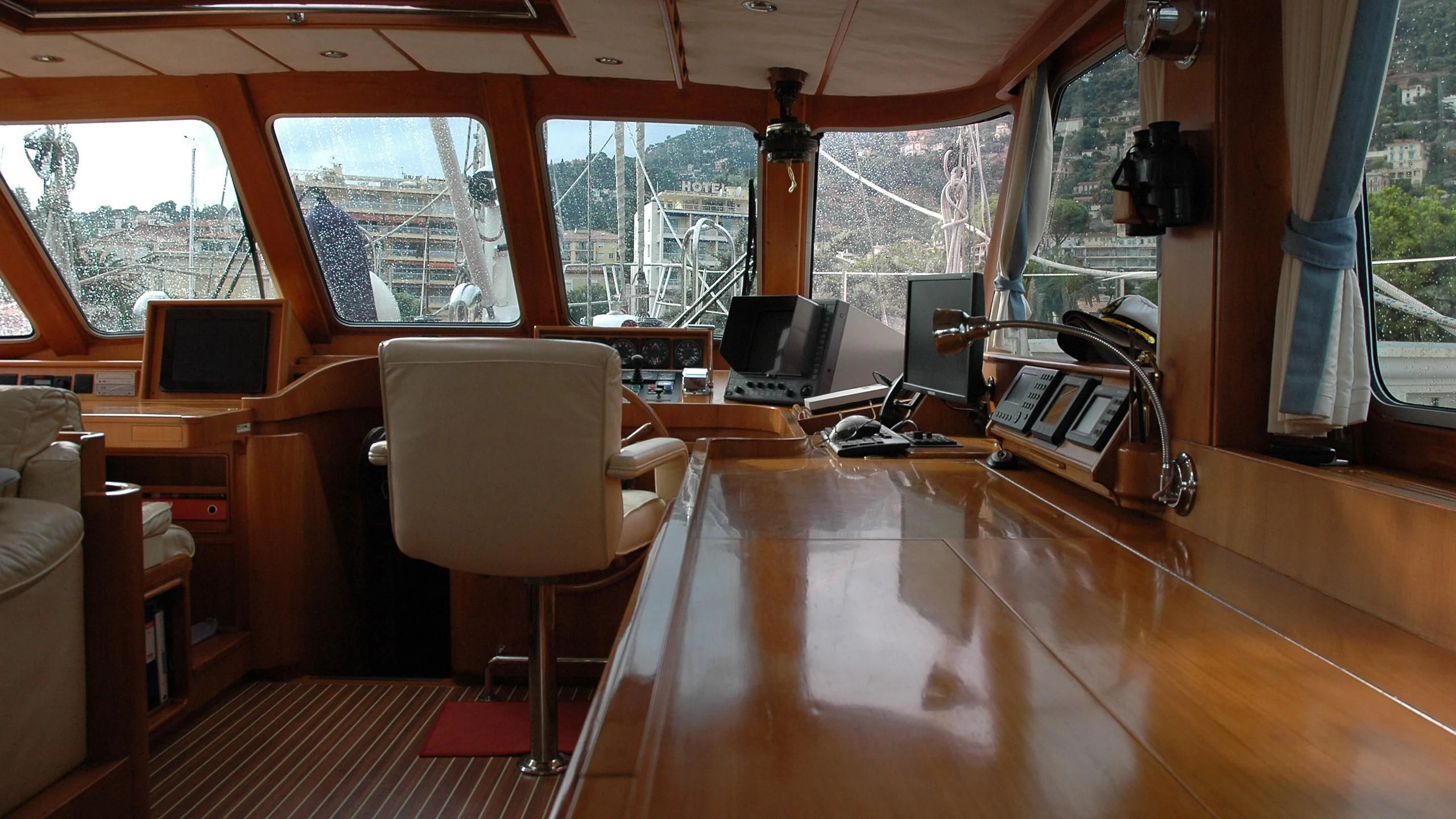 a room with a wood floor and a desk with computers and a window aboard ISABEL Yacht for Sale