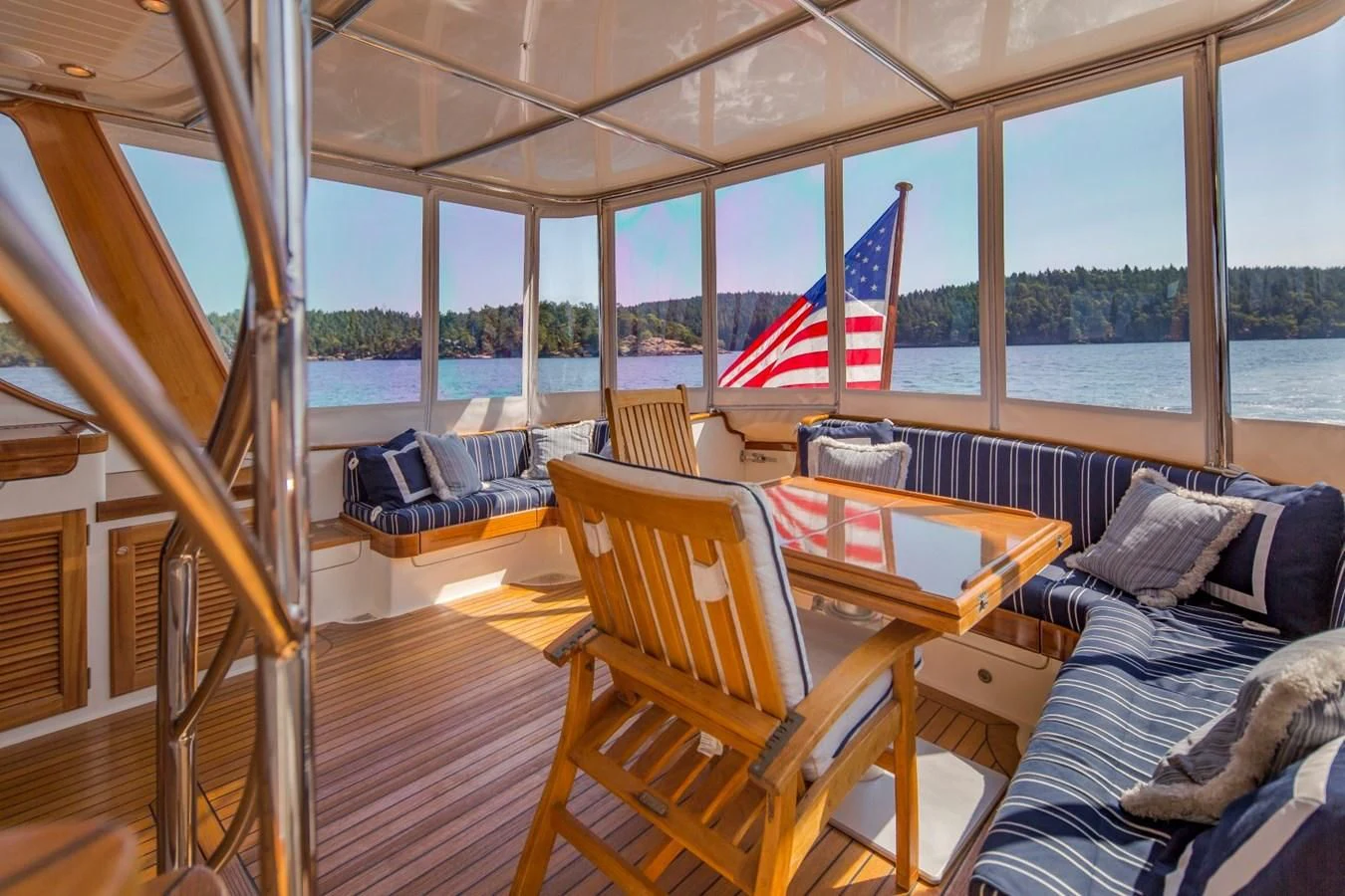 a boat with a flag on the deck aboard REVELRY Yacht for Sale