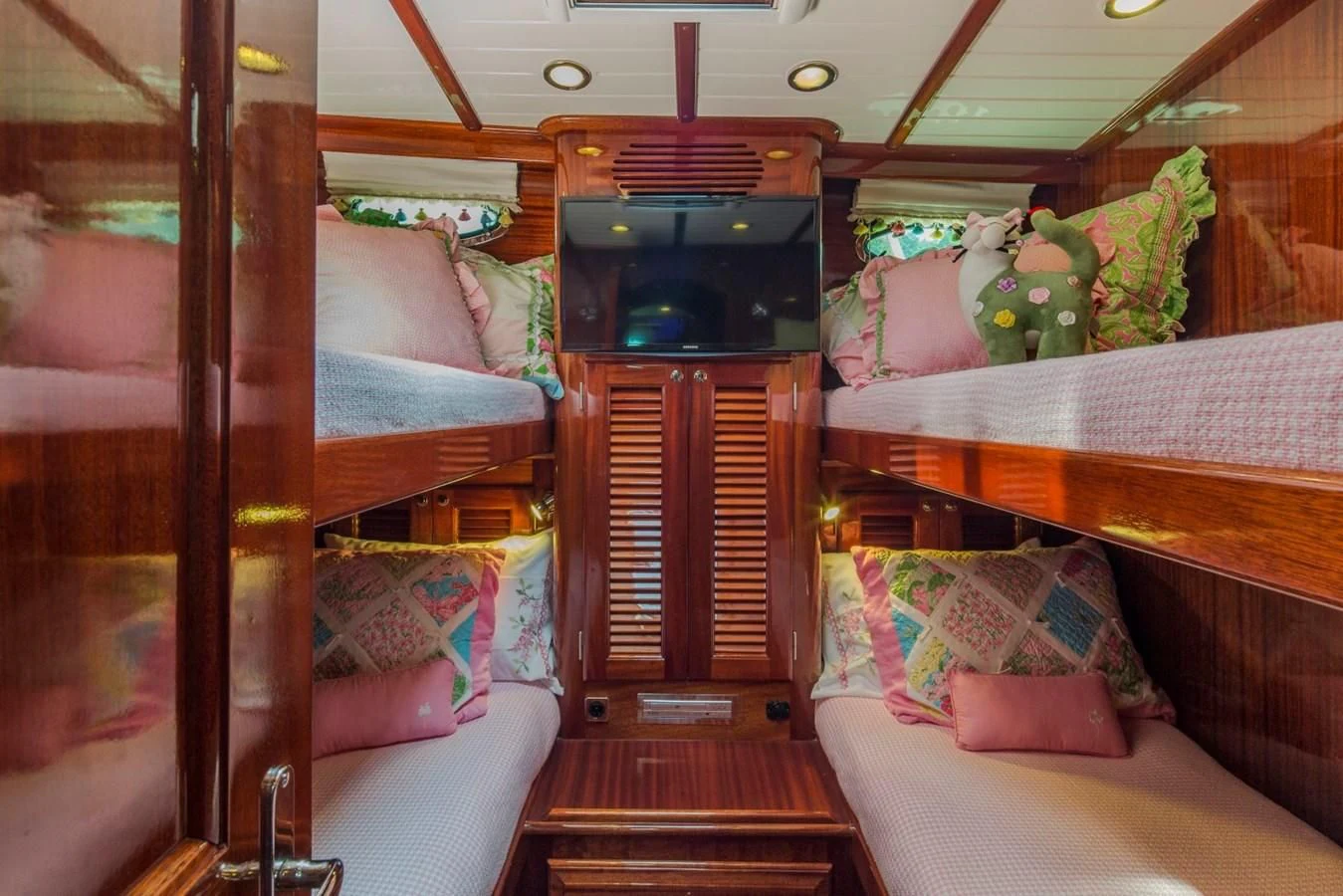 a room with a bed and a television aboard REVELRY Yacht for Sale