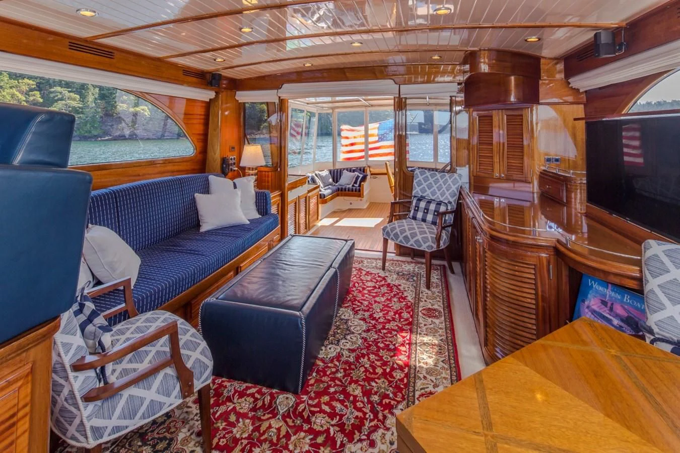 a living room with a couch and a tv aboard REVELRY Yacht for Sale