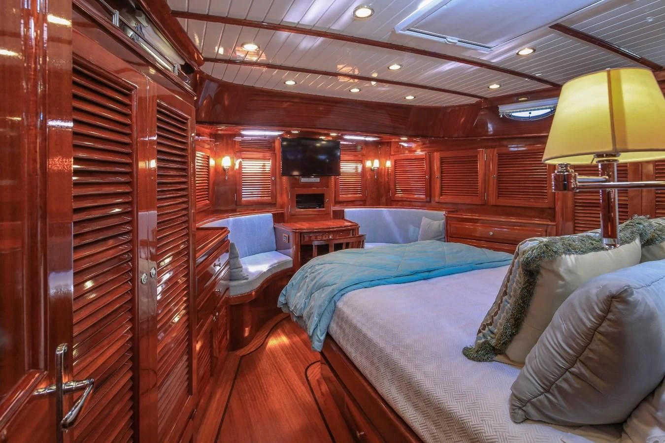 a room with a bed and a chair aboard REVELRY Yacht for Sale