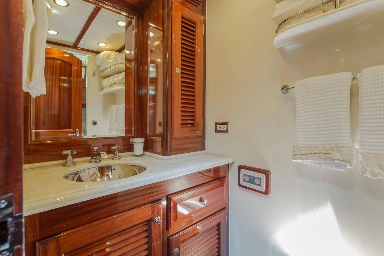 a bathroom with a large mirror aboard REVELRY Yacht for Sale