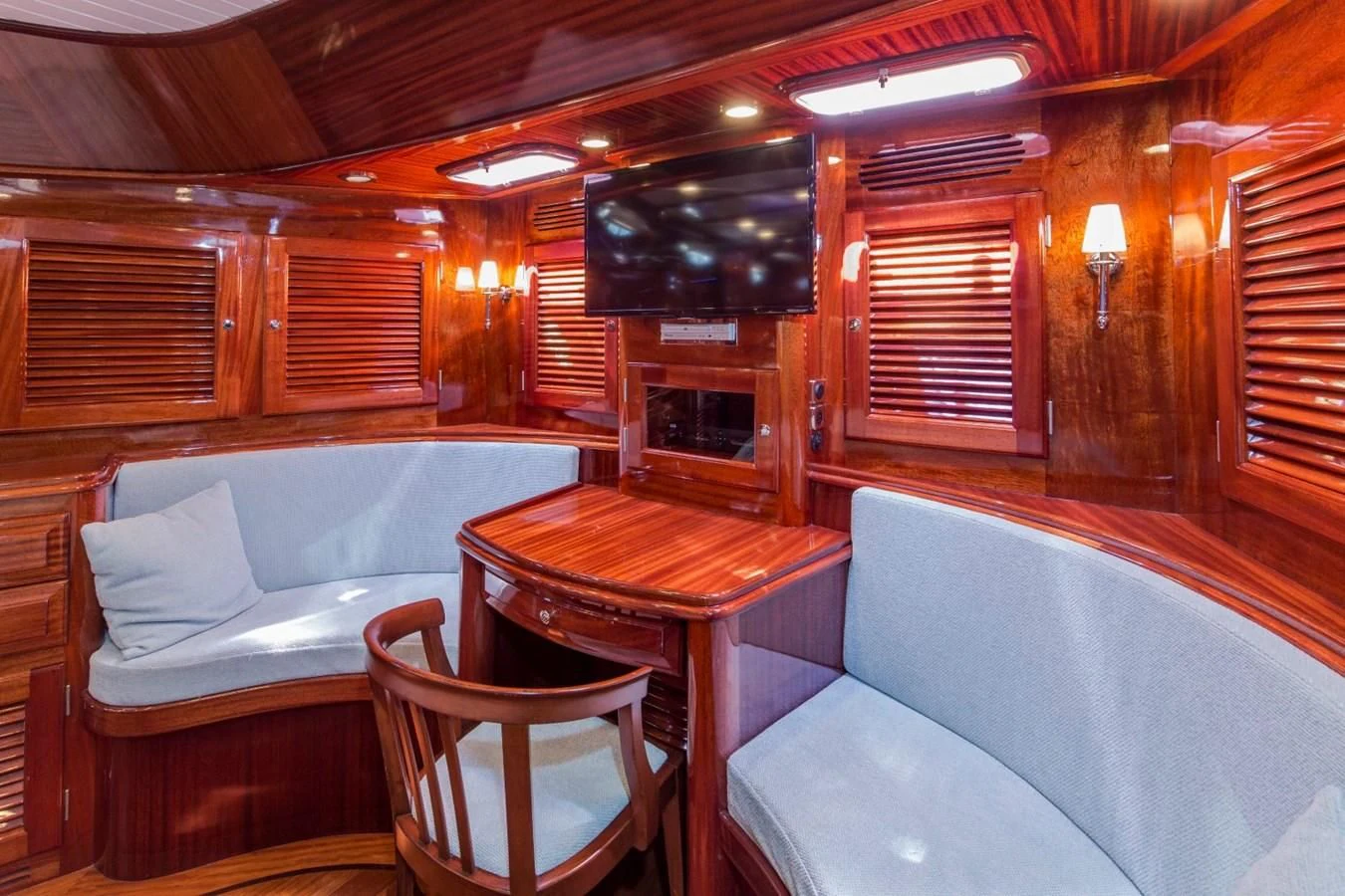 a cabin with a table and chairs aboard REVELRY Yacht for Sale