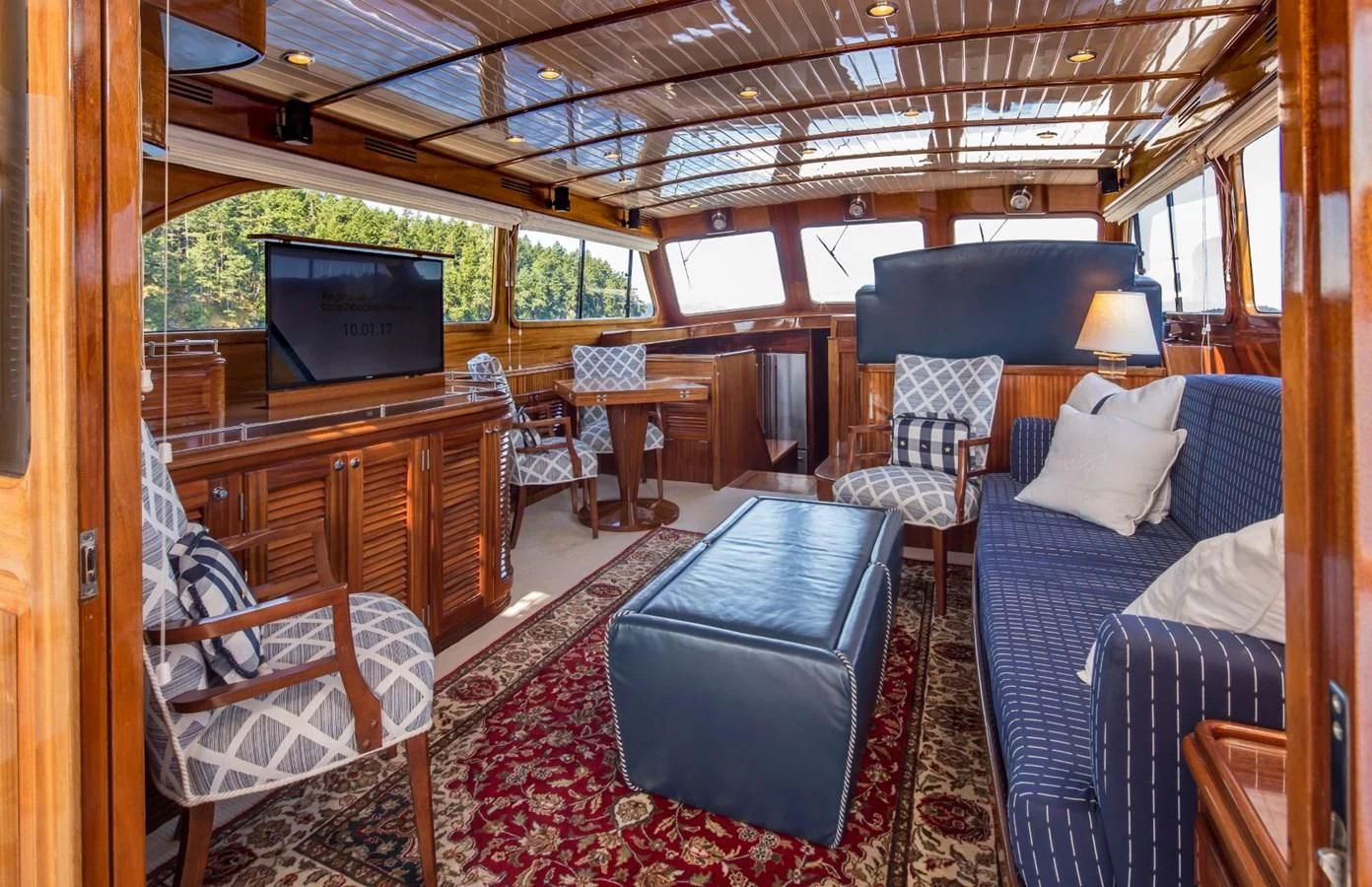 a cabin with a tv and a couch aboard REVELRY Yacht for Sale