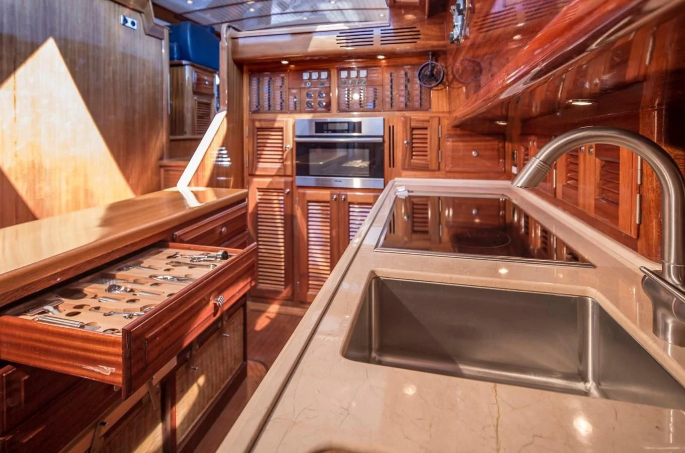 a kitchen with wooden cabinets aboard REVELRY Yacht for Sale
