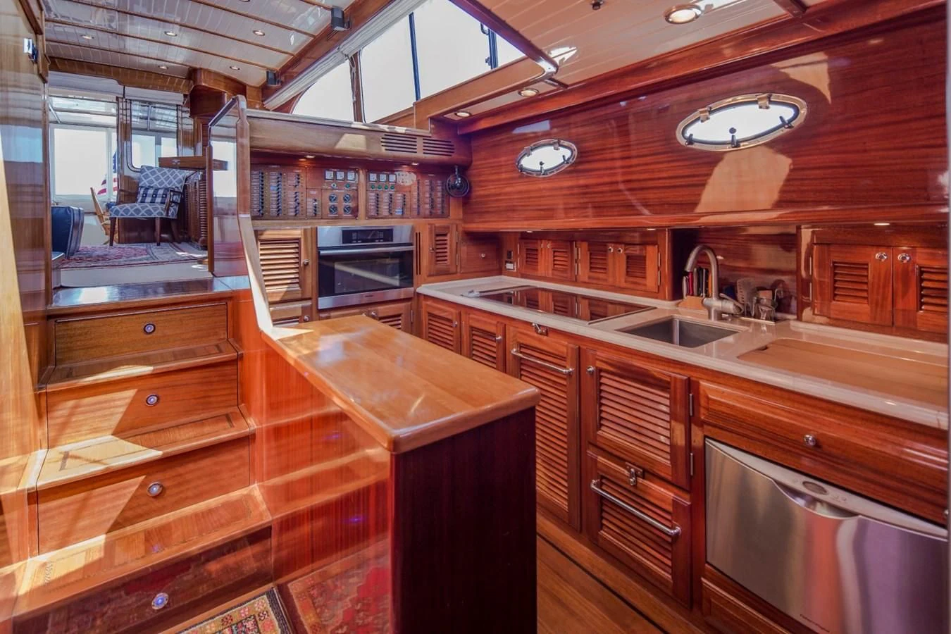 a kitchen with wooden cabinets aboard REVELRY Yacht for Sale