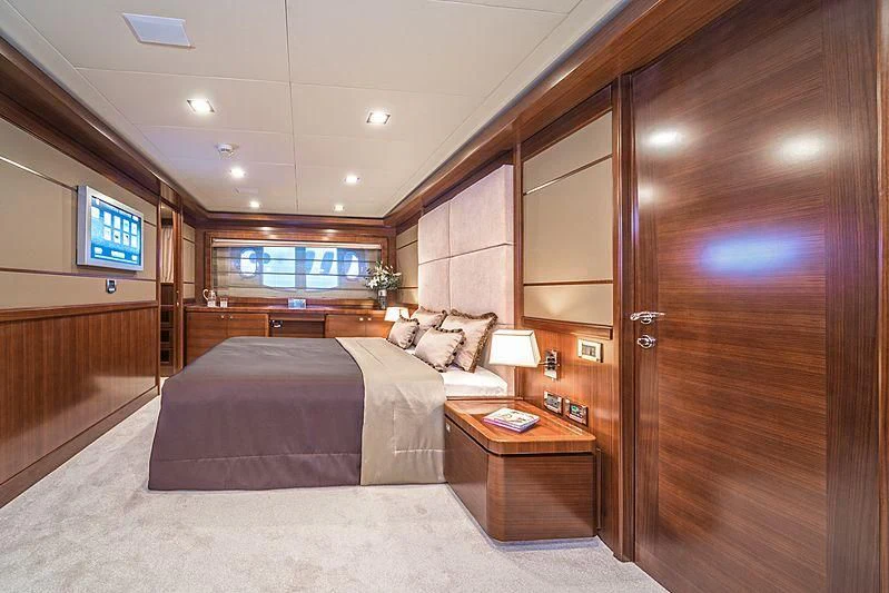 a bedroom with a bed and a tv aboard SEVENTH SENSE Yacht for Charter
