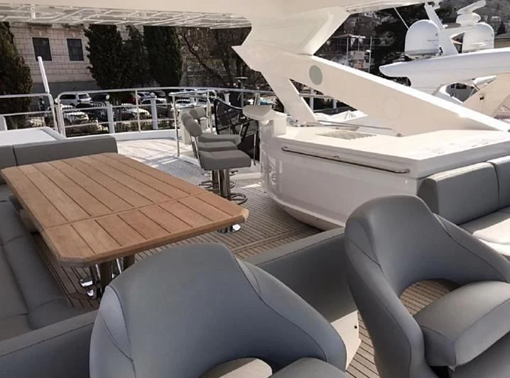 a table and chairs on a deck aboard ZODIAC Yacht for Sale