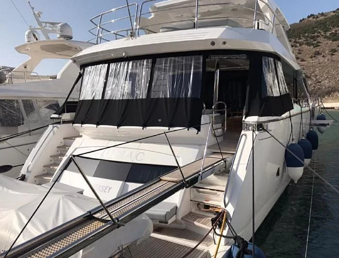 a white boat with a black and white striped front aboard ZODIAC Yacht for Sale