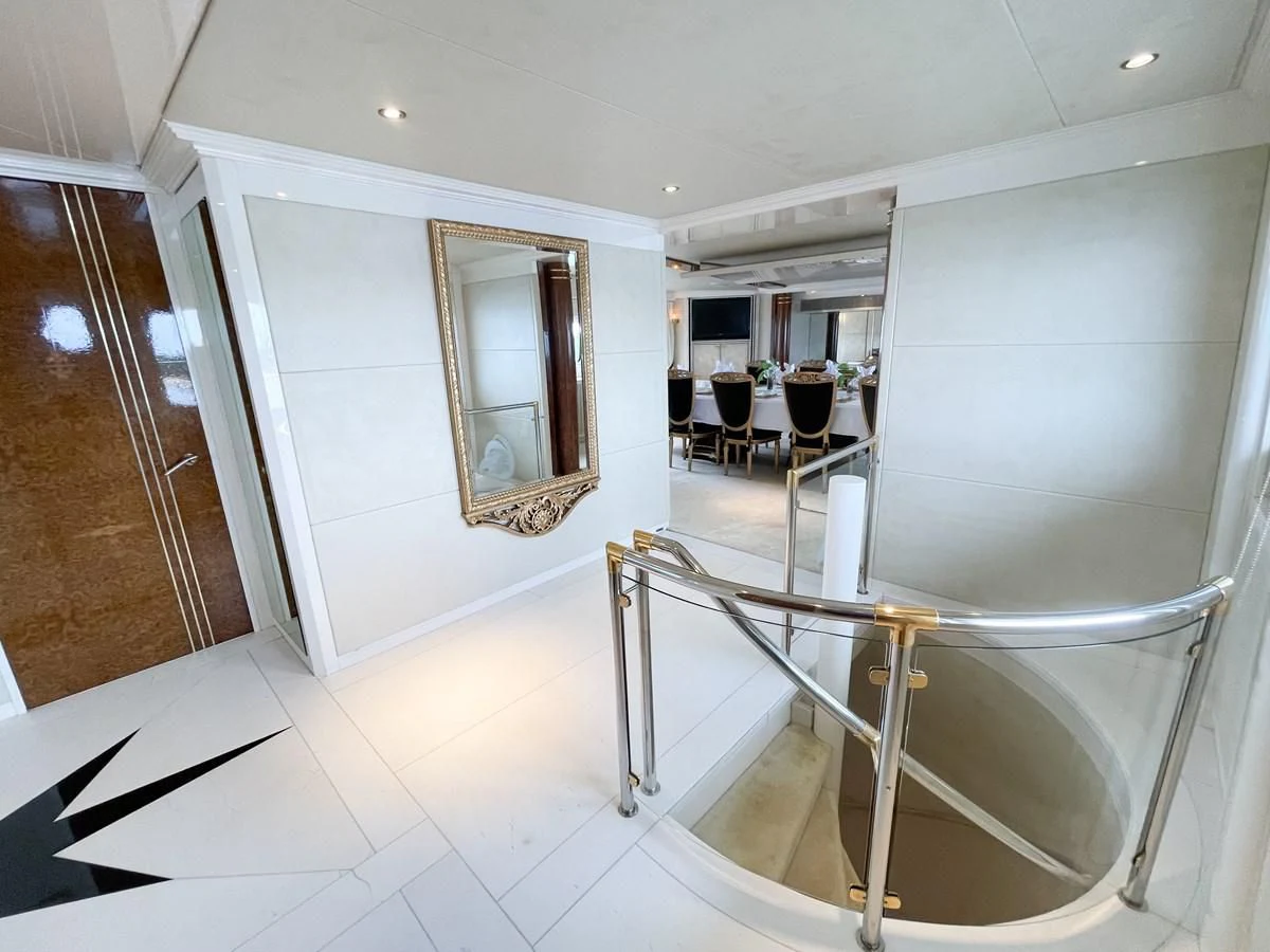 a large white room with a glass table and chairs aboard OBSESSIONS Yacht for Sale