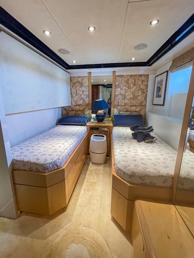 a bedroom with a couple beds aboard OBSESSIONS Yacht for Sale