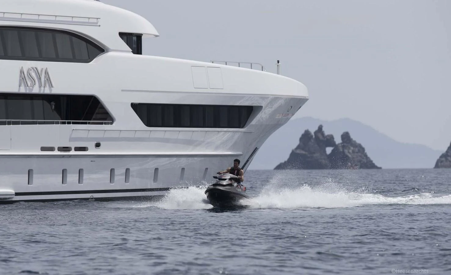 a person on a jet ski in the water next to a boat aboard ASYA Yacht for Sale
