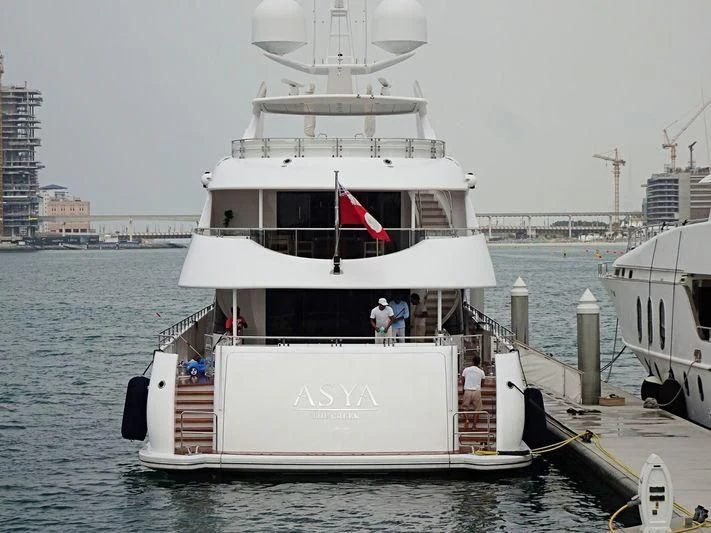 a large white boat with a flag on it aboard ASYA Yacht for Sale