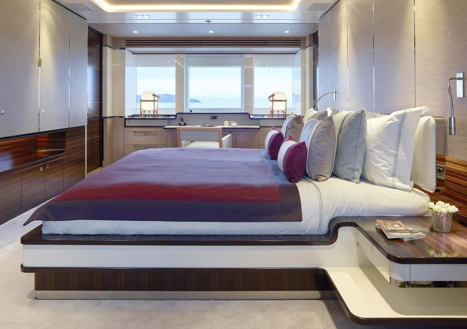 a bed with a red and blue blanket aboard ASYA Yacht for Sale