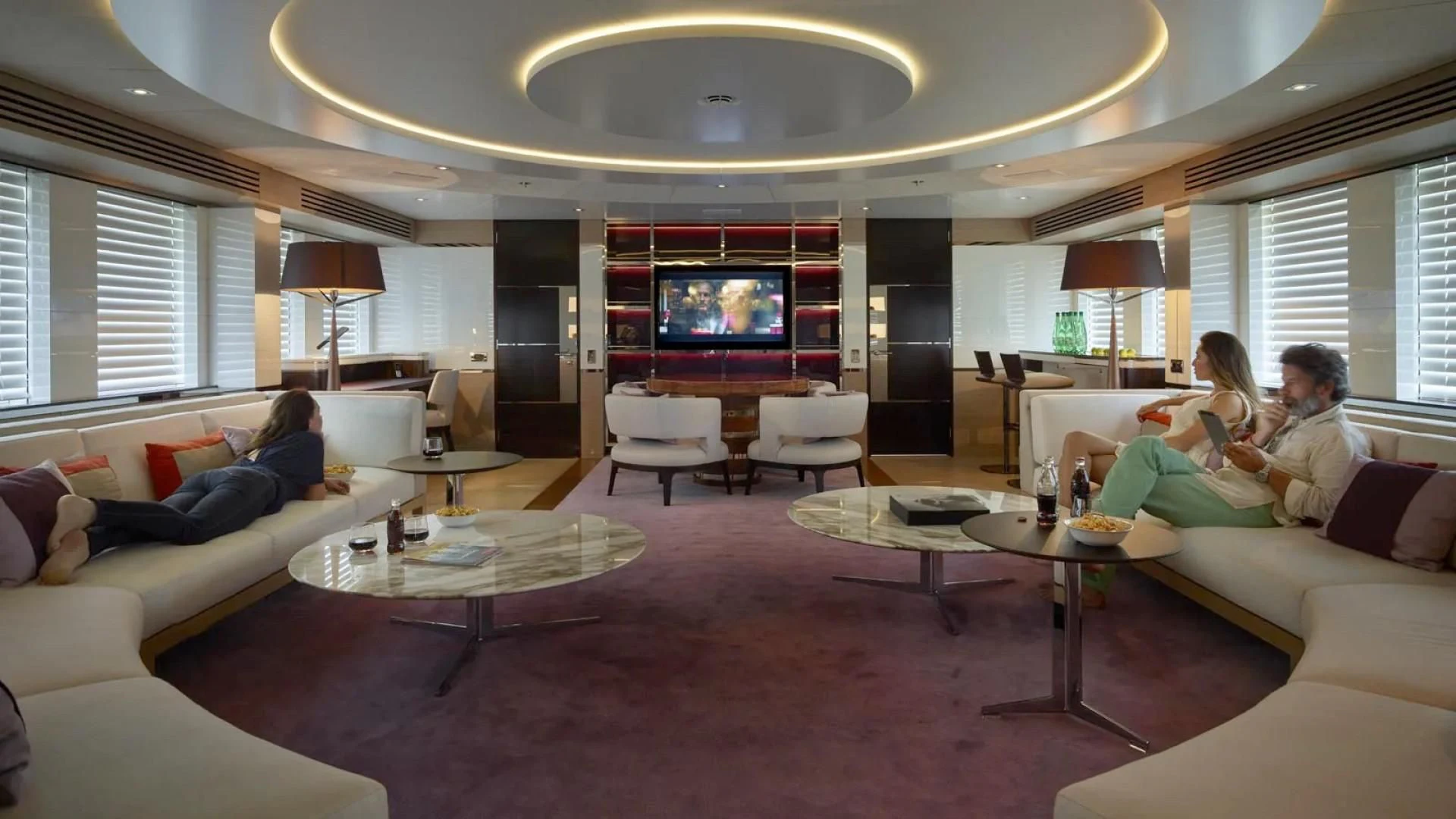 a couple of people sitting on a couch in a living room aboard ASYA Yacht for Sale