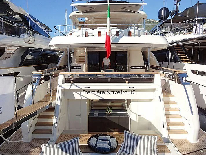 a boat with a flag on the deck aboard FOUR FLOWERS III Yacht for Sale