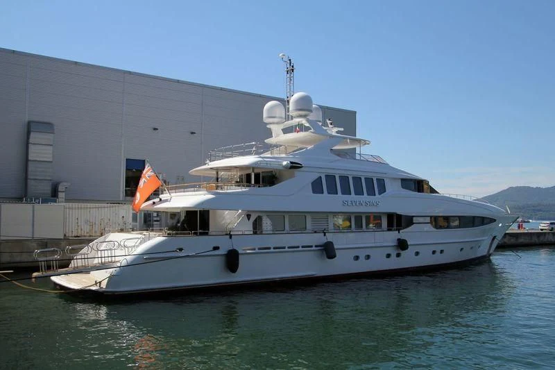 a large white boat in a harbor aboard THE LADY K Yacht for Sale