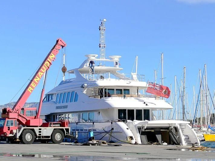 a large white boat with a crane on top aboard THE LADY K Yacht for Sale