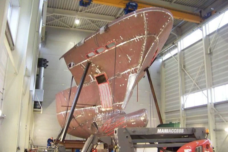 a large red airplane in a building aboard THE LADY K Yacht for Sale