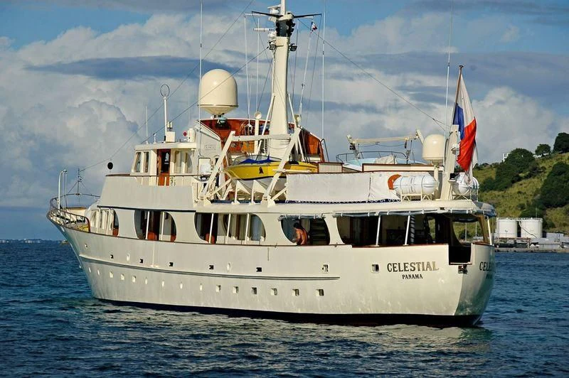 a large white boat on the water aboard CELESTIAL Yacht for Sale