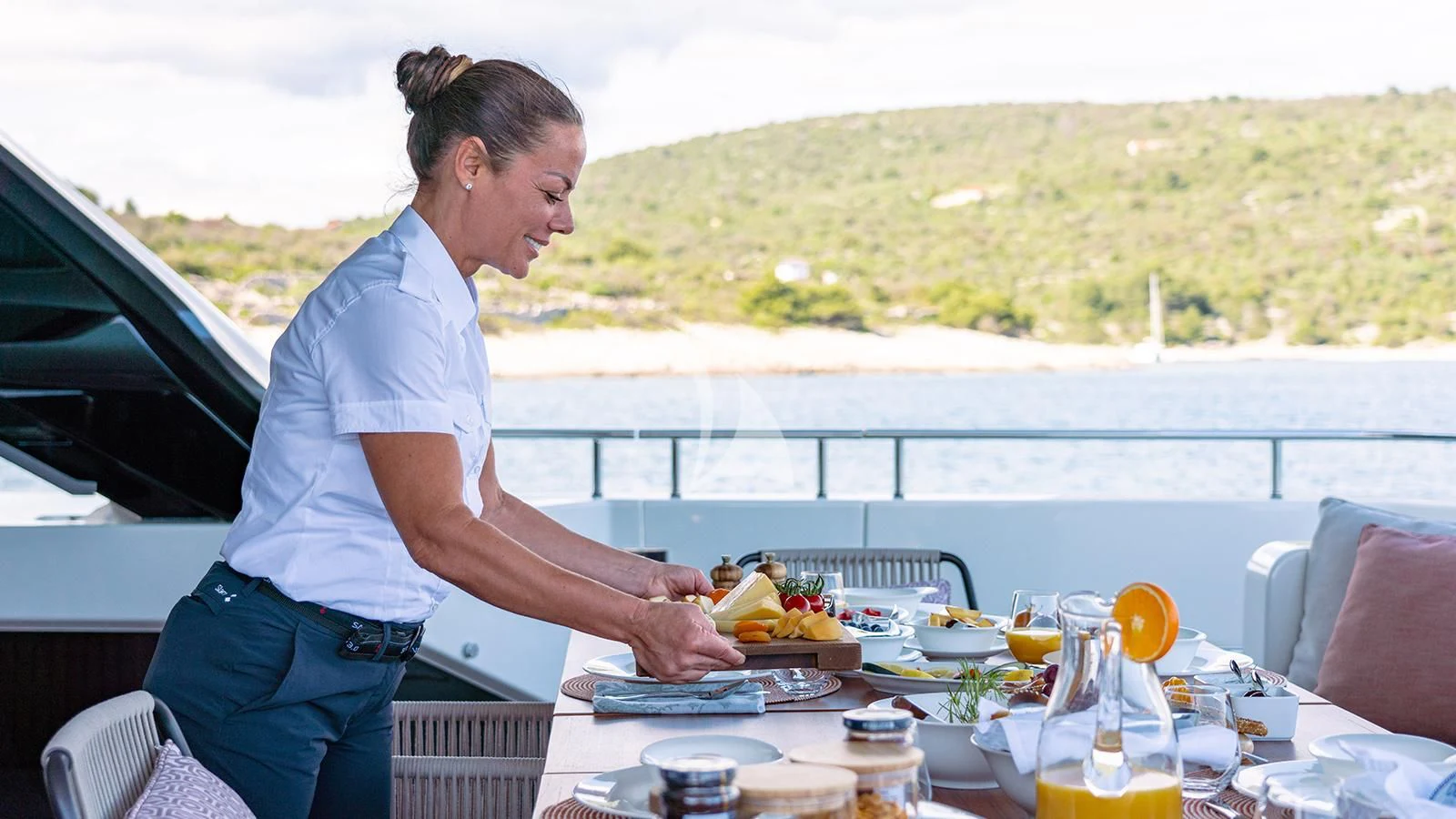 a person preparing food on a table aboard JOURNEY Yacht for Sale