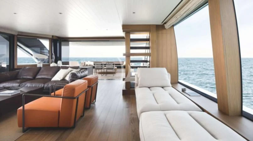 a living room with a couch and a large window aboard JOURNEY Yacht for Sale
