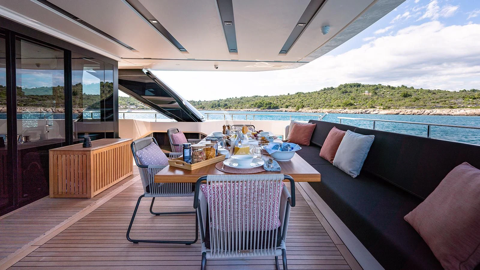 a large open living room with a view of the mountains aboard JOURNEY Yacht for Sale
