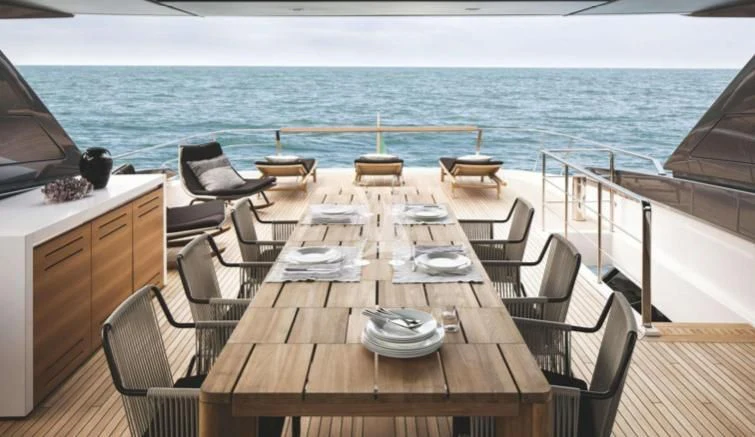 a table set for a meal on a deck overlooking the ocean aboard JOURNEY Yacht for Sale