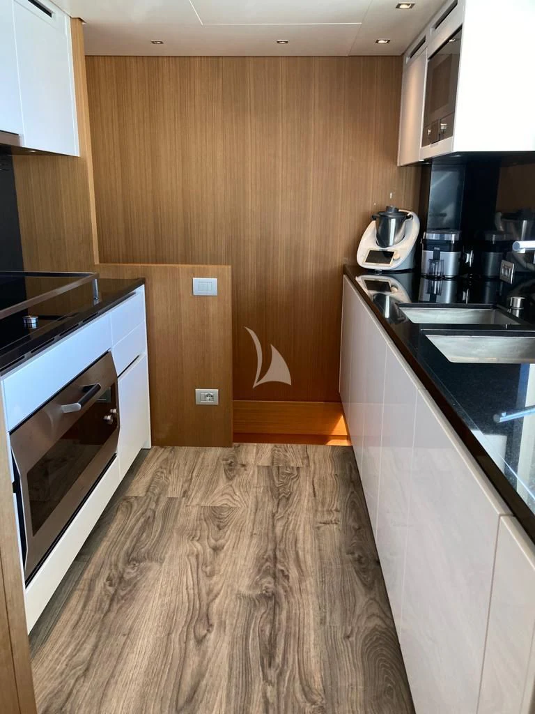 a kitchen with wooden cabinets aboard JOURNEY Yacht for Sale