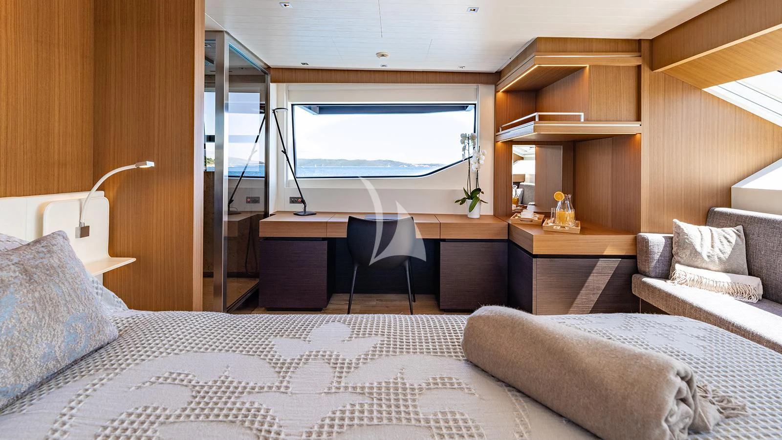 a bedroom with a bed and a desk aboard JOURNEY Yacht for Sale