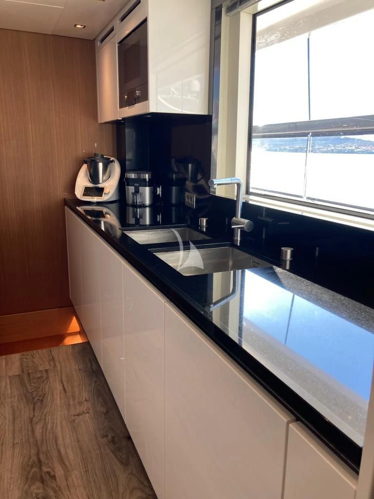 a kitchen with a large island aboard JOURNEY Yacht for Sale