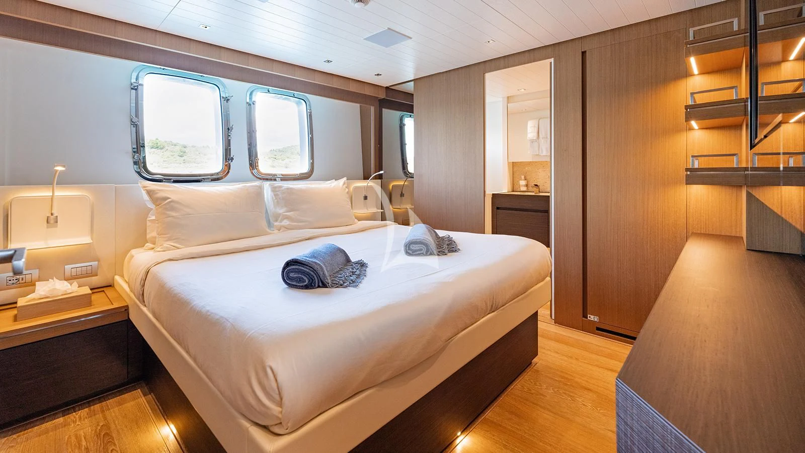 a room with a bed and a desk aboard JOURNEY Yacht for Sale