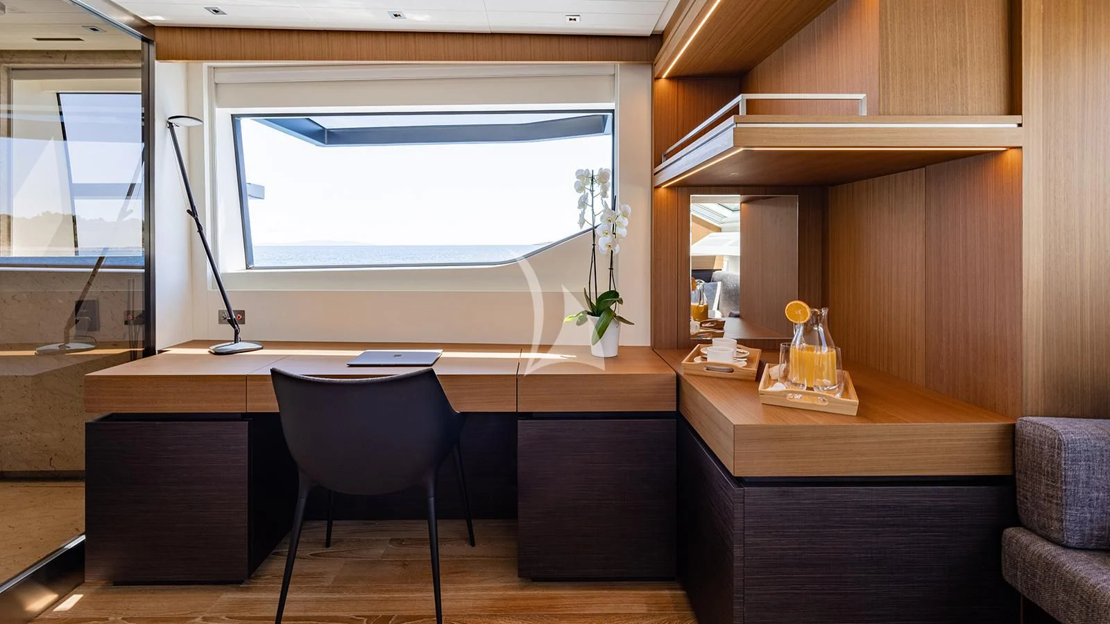 a room with a desk and a window aboard JOURNEY Yacht for Sale