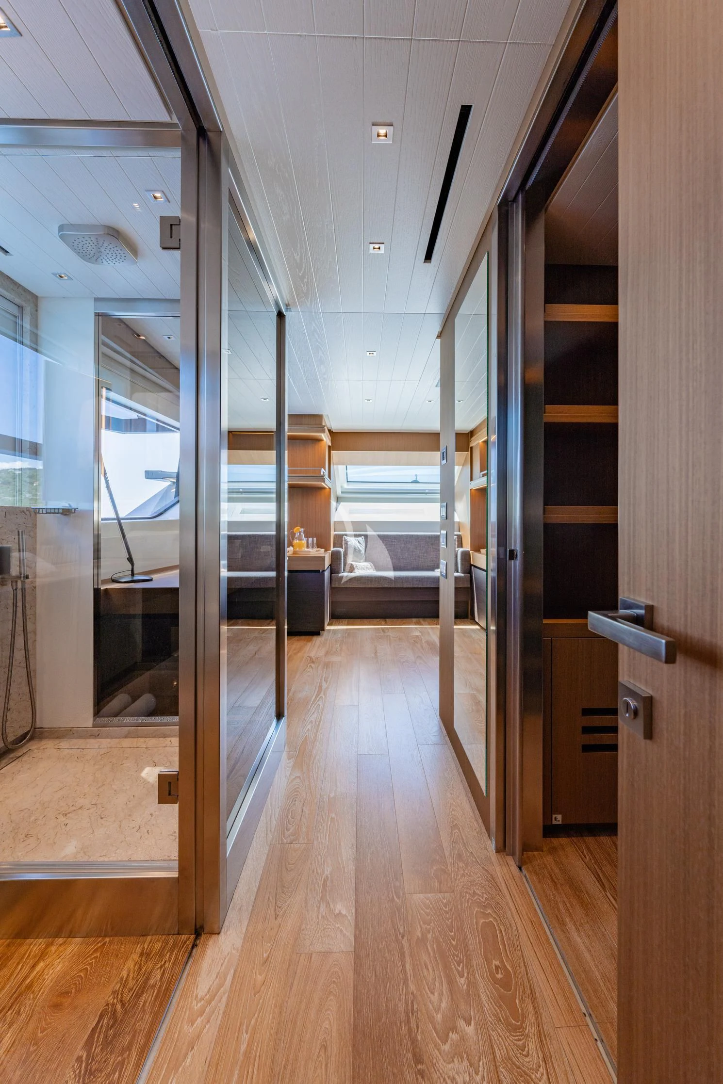 a room with a wood floor and a glass door aboard JOURNEY Yacht for Sale