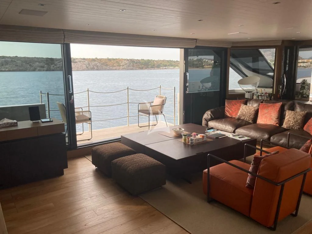 a living room with a large window aboard JOURNEY Yacht for Sale