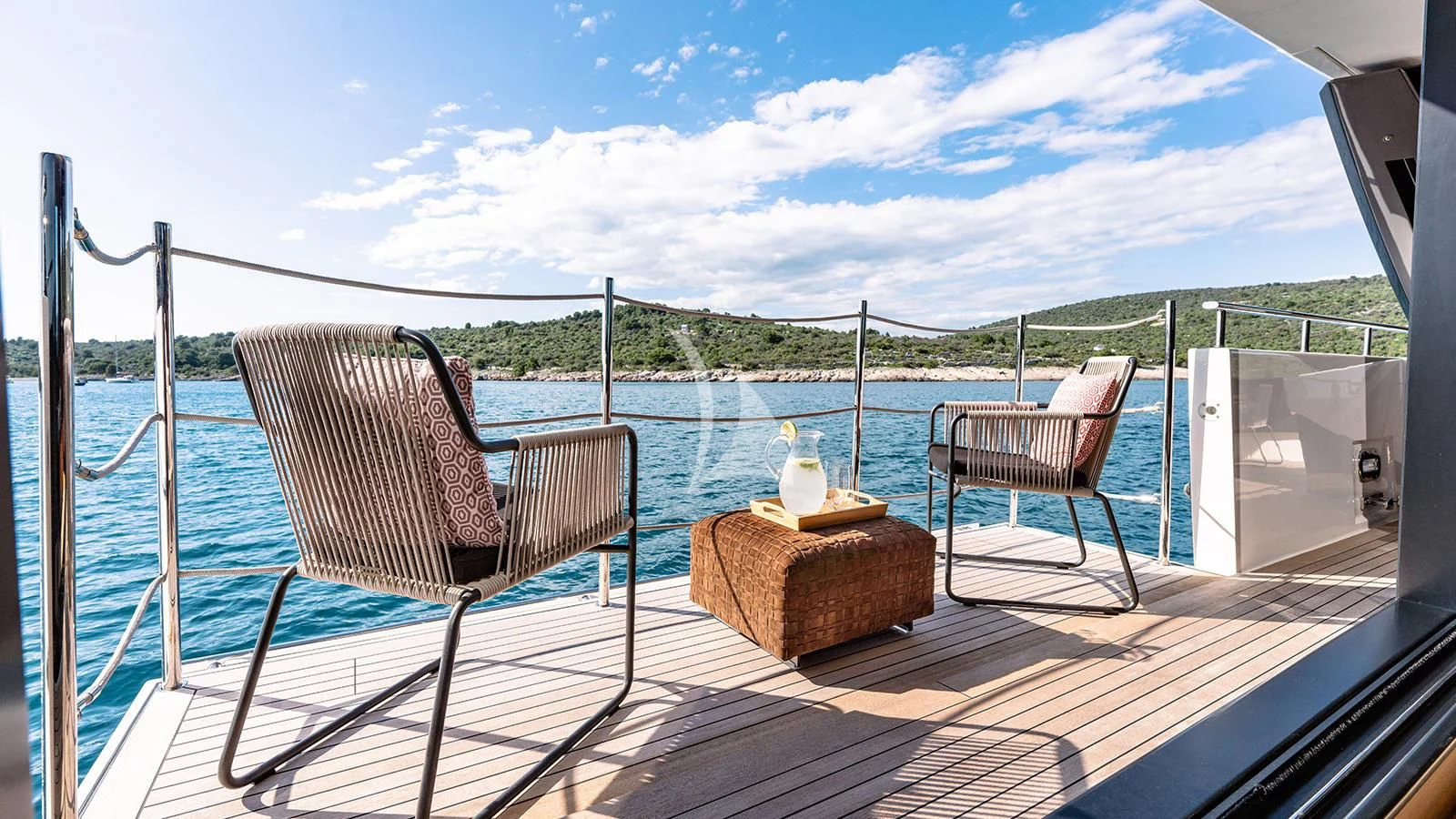 a deck with chairs and a table on it aboard JOURNEY Yacht for Sale