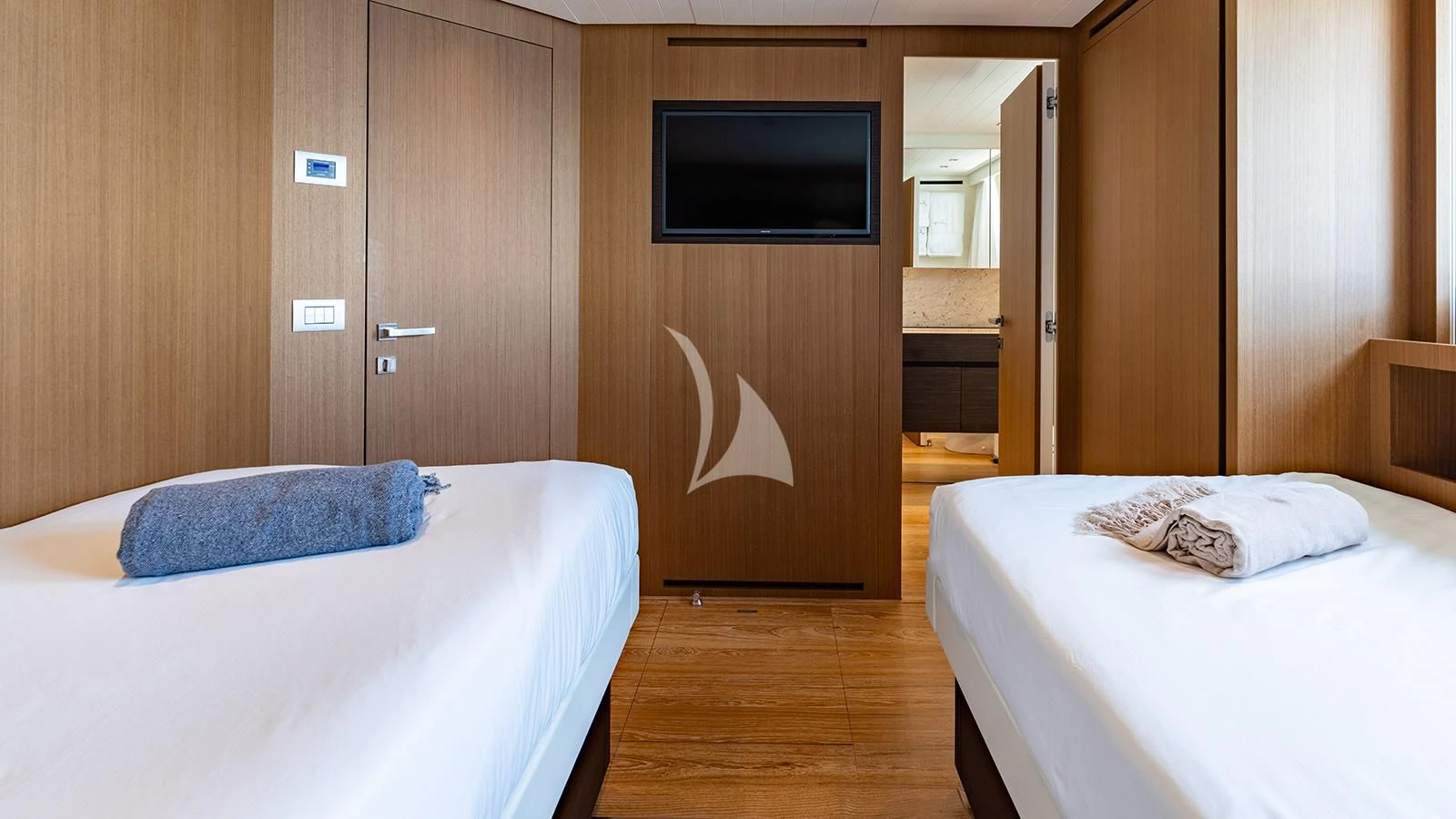 a room with a bed and a television aboard JOURNEY Yacht for Sale