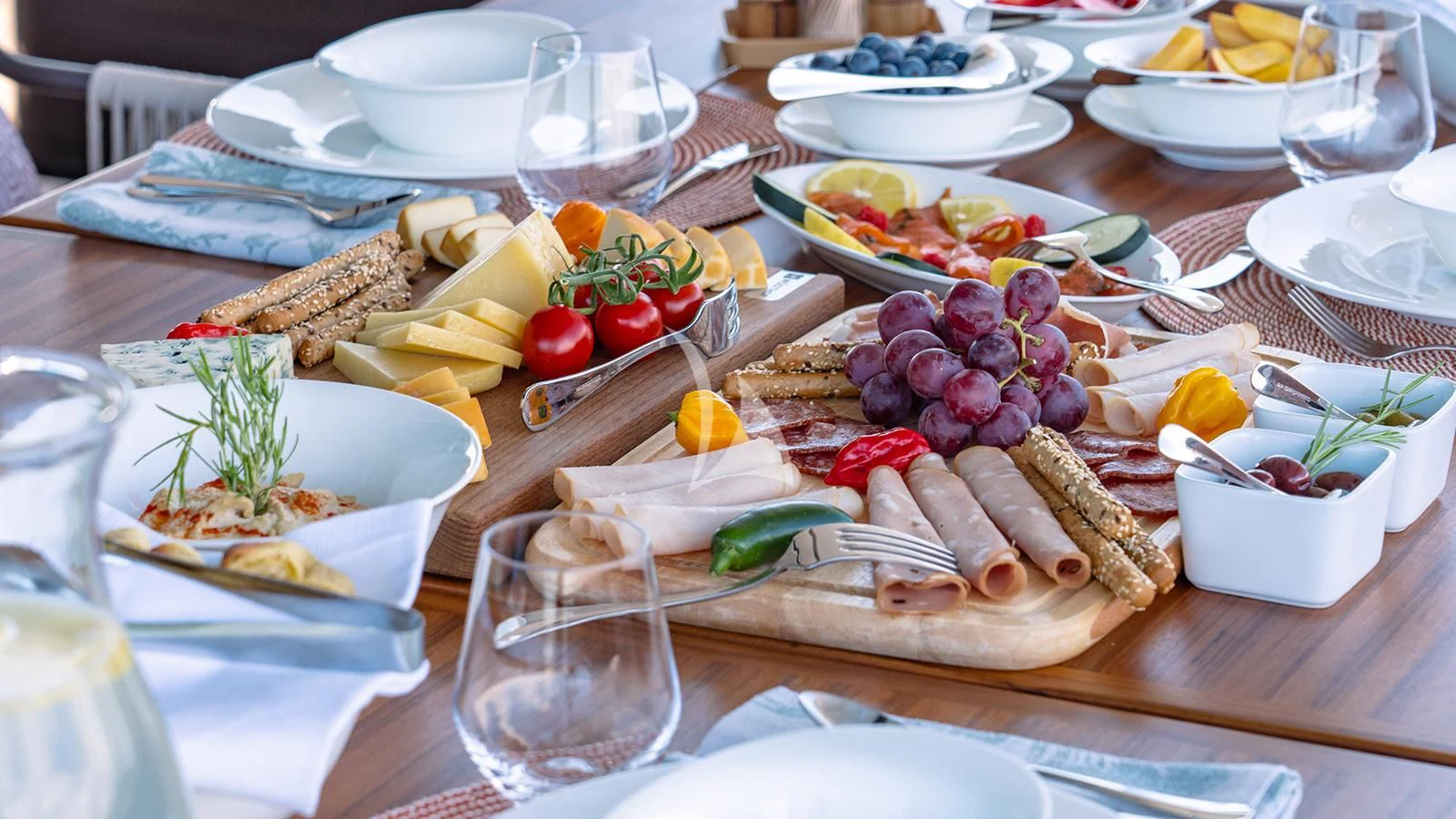 a table with food and plates aboard JOURNEY Yacht for Sale