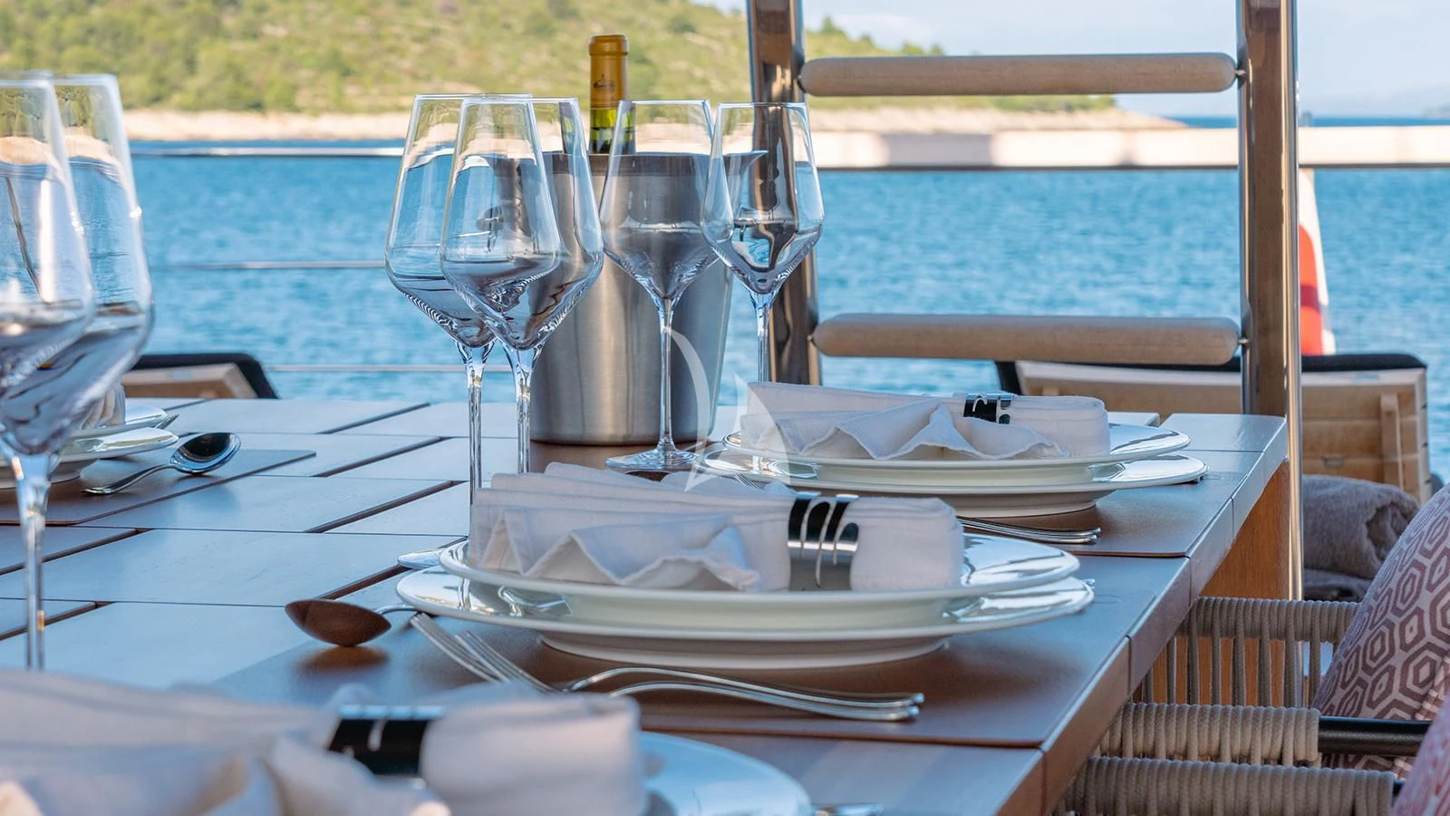 a table with plates and glasses on it aboard JOURNEY Yacht for Sale