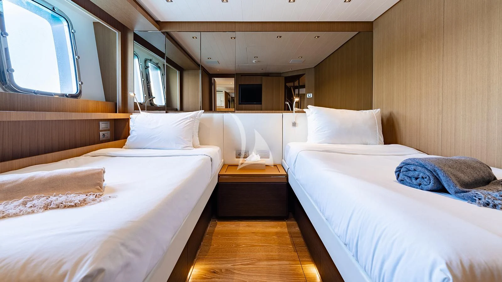 a room with beds and a window aboard JOURNEY Yacht for Sale
