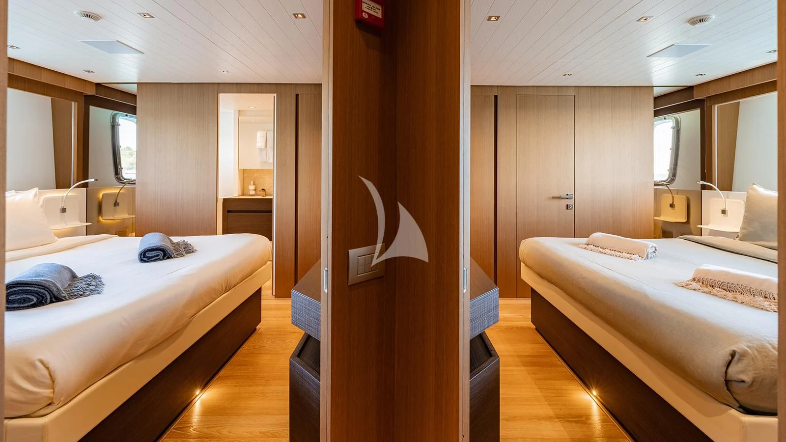 a room with beds and a mirror aboard JOURNEY Yacht for Sale